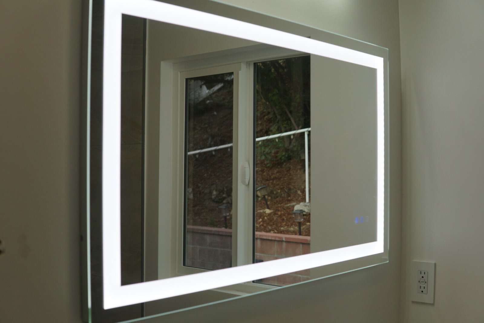 Bathroom with LED-lit mirror, GFCI outlet, and modern lighting installed by LAProElectrical.