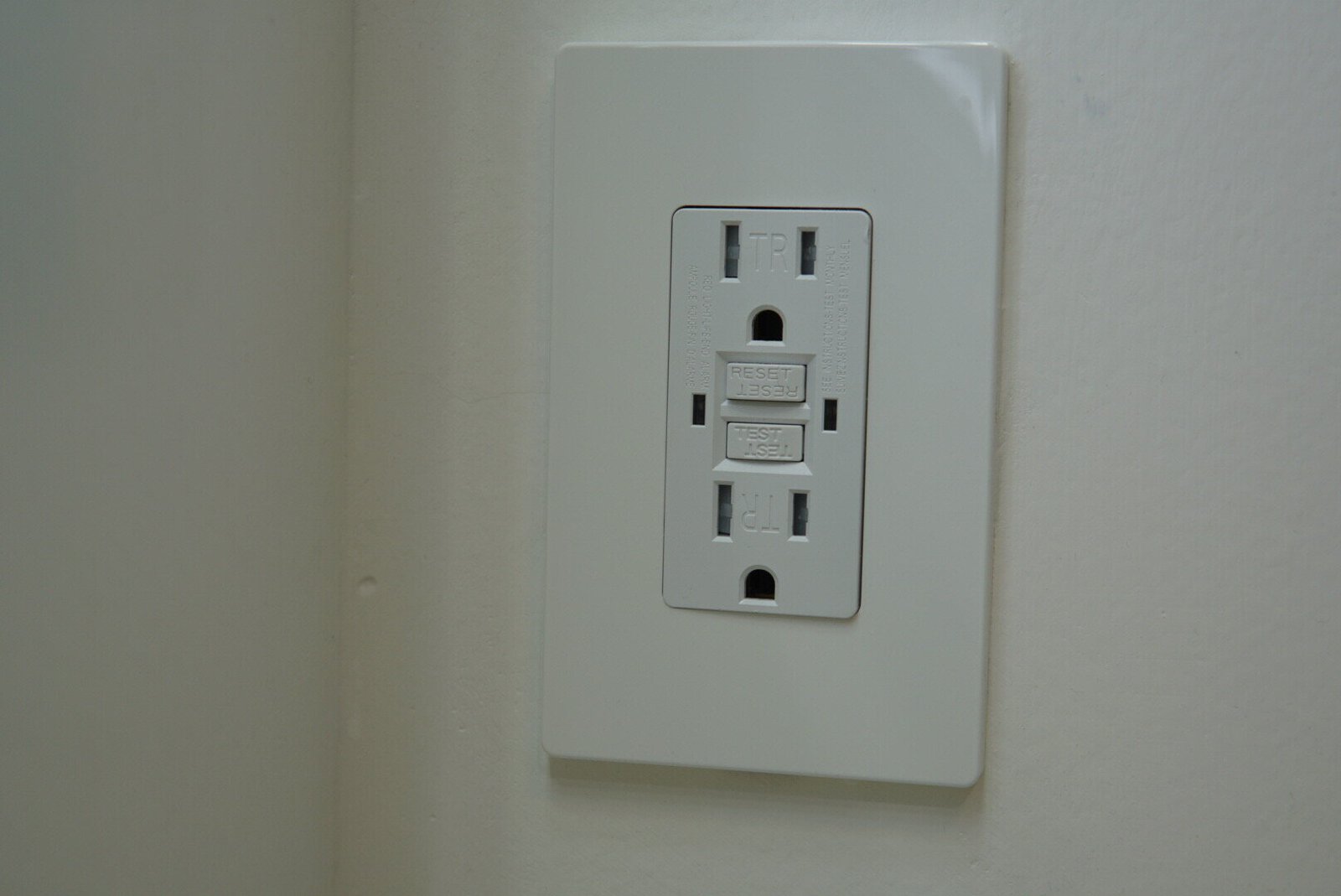 Modern GFCI switch installed on a white wall, designed for safety and reliability in residential electrical systems.