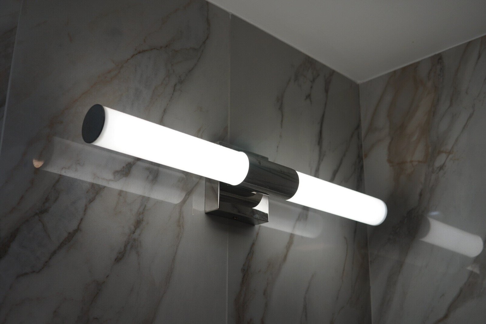Custom vanity lighting with elegant fixtures illuminating a modern bathroom.