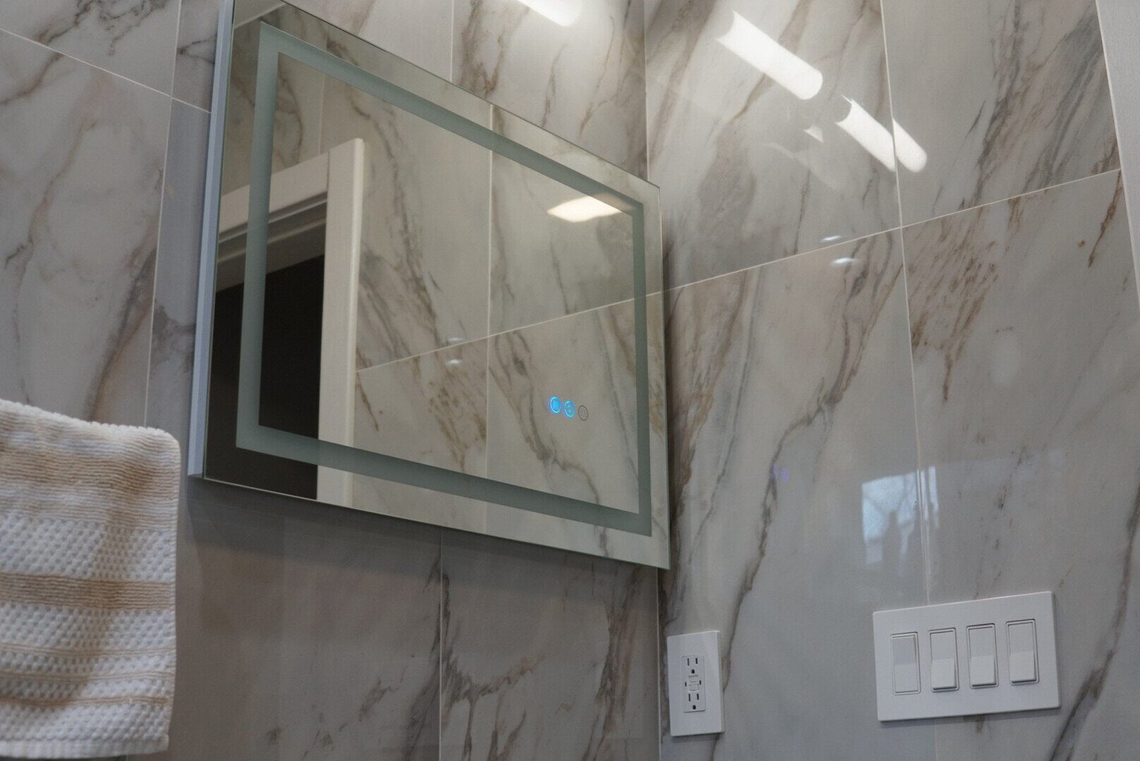 Custom bathroom vanity mirror with LED lighting installed for a modern and illuminated look.